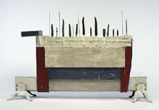 Hurdle for Art Lovers (1962) Assemblage of wood, cast iron, plastic belt, oil-based paint, ink, silver knives, stainless steel knives with wooden and plastic handles, aluminum knitting needles, bamboo stick, silver spoons, steel screwdriver blade, and mastic knife, 100 x 158 x 26.4 cm. National Gallery of Canada. ©The Estate of Greg Curnoe 